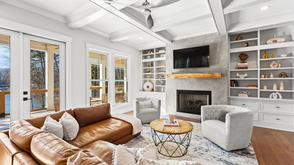 Spacious open-concept living room with large windows.