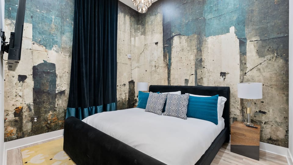 The primary bedroom features a king bed, TV and an ensuite bathroom.