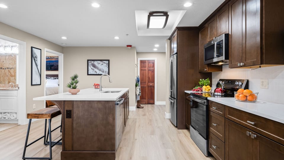 Fully equipped kitchen with sleek appliances, a spacious island for casual dining, and plenty of counter space for easy meal prep.