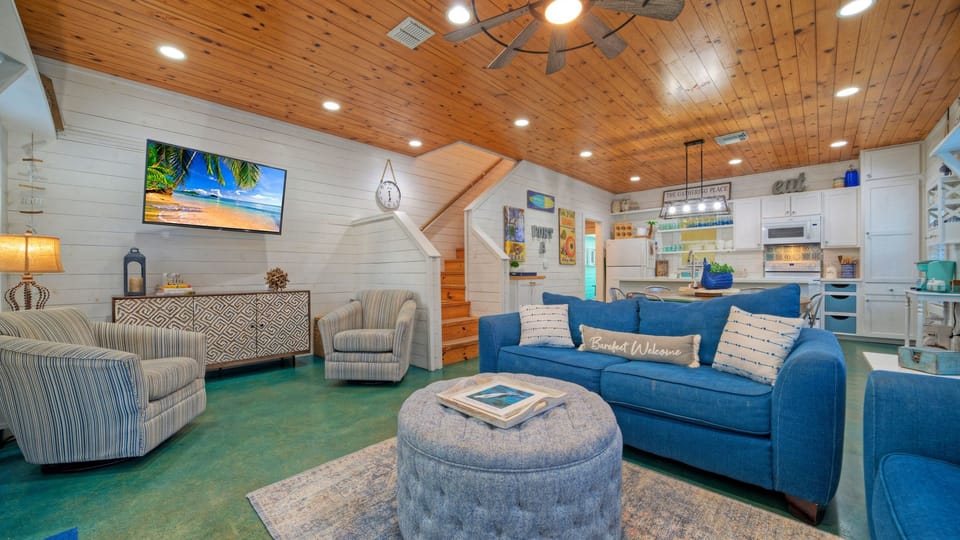 Bright, coastal-inspired living space with vaulted wood ceilings—perfect for gathering, relaxing, and unwinding after a day at the beach.