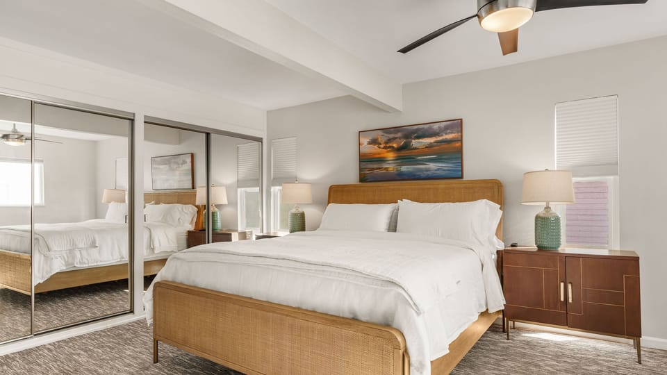 The primary bedroom features a king bed and a TV.