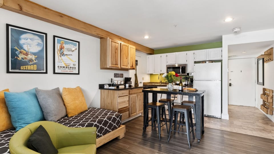 Studio space featuring a daybed and a modern kitchen island.
