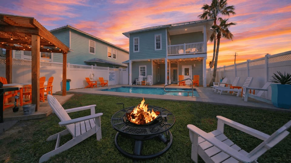 Sun-soaked backyard with a private pool, fire pit lounge, and pergola dining—your perfect Port A hangout from day to night.