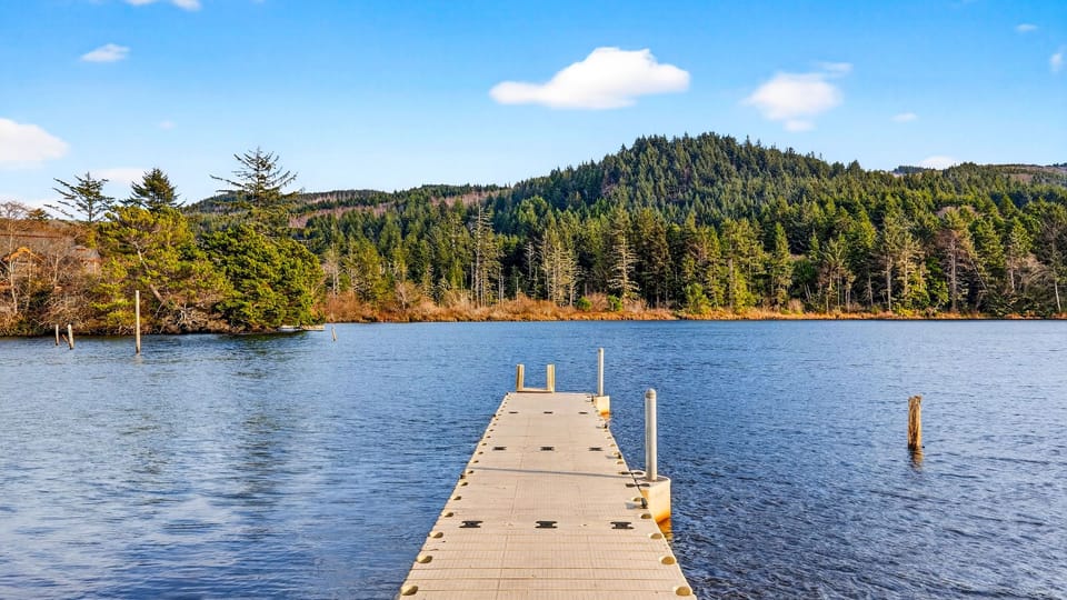 Community dock overlooking the tranquil lake and surrounding forested hills.