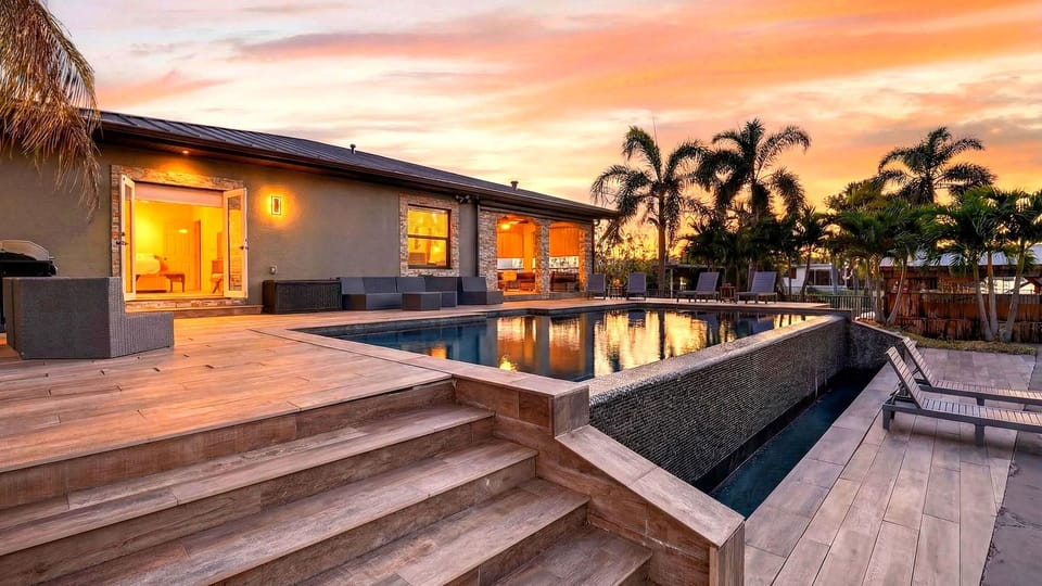 Waterfront living with a private dock, pool and lush tropical surroundings.