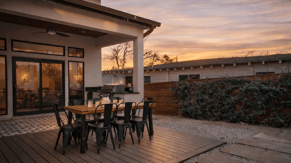Sweeping aerial view at sunset showcasing the neighborhood and Austin skyline in the distance.
