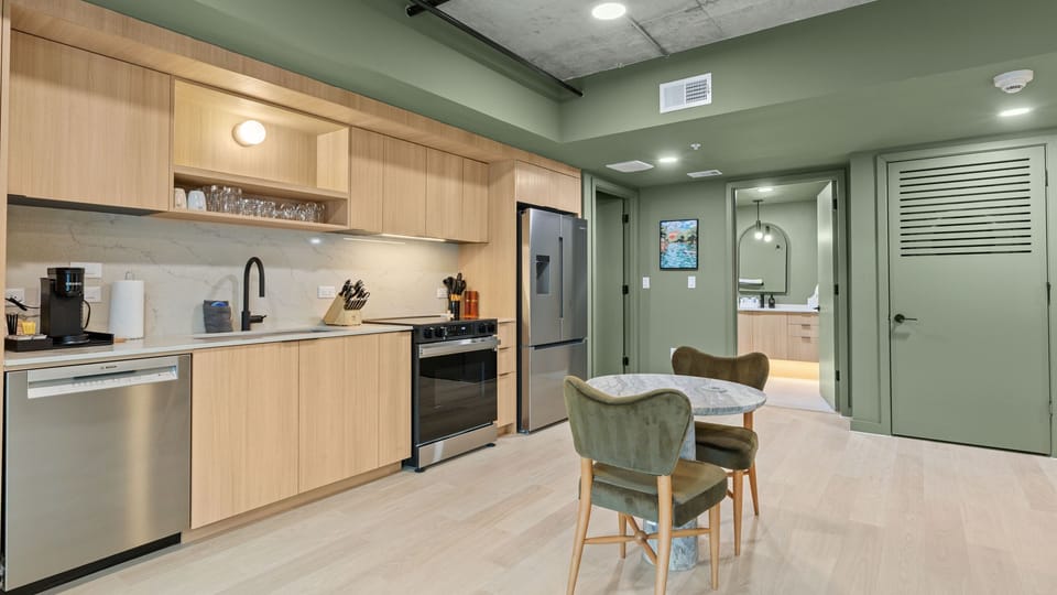 Whip up meals with ease in the sleek full kitchen featuring modern appliances, ample prep space, and a cozy dining nook.