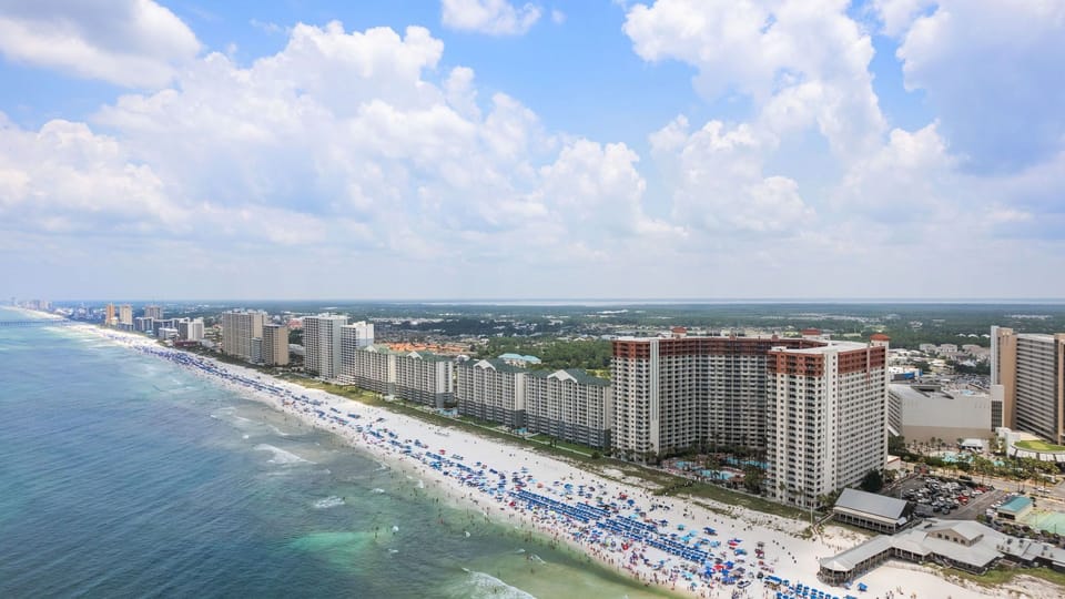 A sweeping aerial view of the resort, steps from the white-sand shoreline of PCB’s emerald coast.