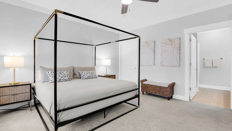 The primary bedroom features a king bed, TV, desk and an ensuite bathroom.
