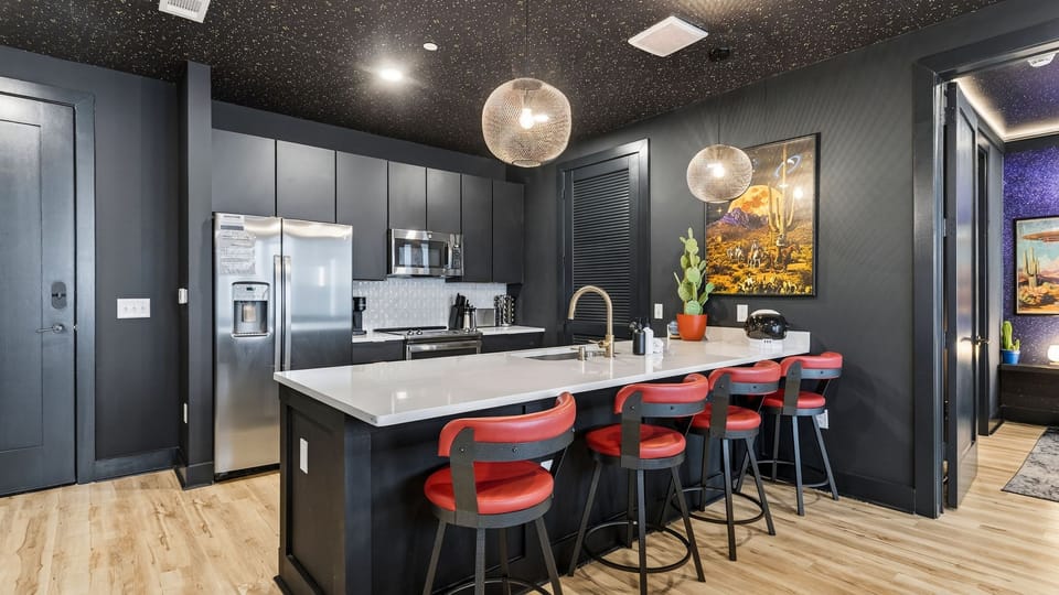 Sleek, fully equipped kitchen with a spacious island, bar seating, and modern finishes—ideal for shared meals, cocktails, and late-night chats before heading out in Nashville.