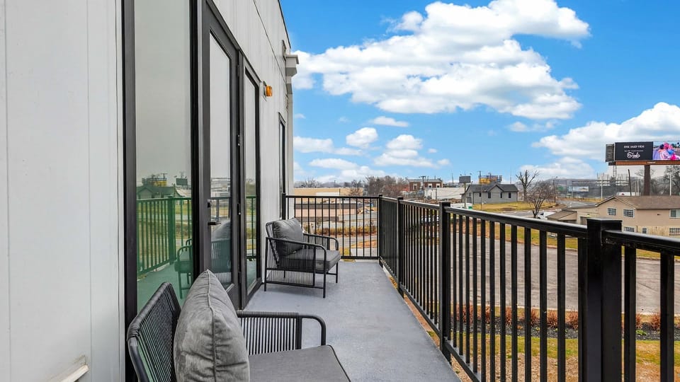 Private balcony with cozy seating and open-air views—perfect for morning coffee, fresh air breaks, or winding down after exploring Nashville.