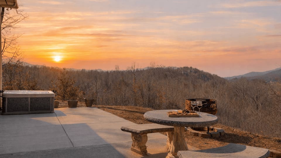 Forest-view patio with hot tub, fire pit, and picnic table for easy outdoor hangs.