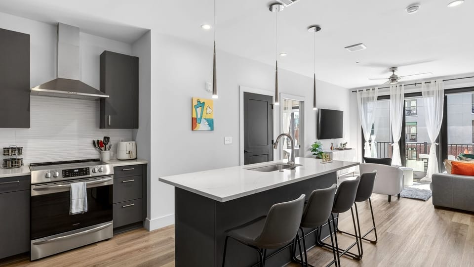 Open-concept kitchen + lounge with a spacious island for meals and mingling.