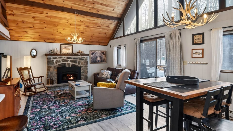 Warm and inviting open-concept living area with a stone fireplace.