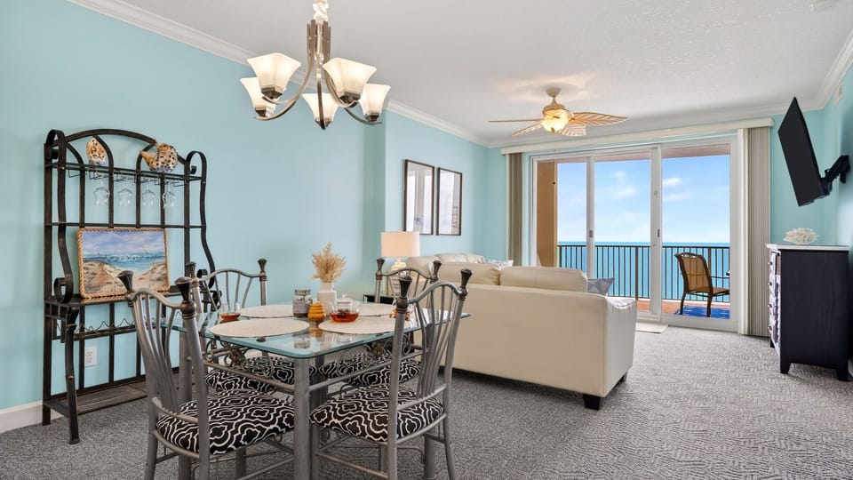 Open-concept living &amp; dining with wall-to-wall Gulf views—step straight onto the balcony for fresh sea breezes.