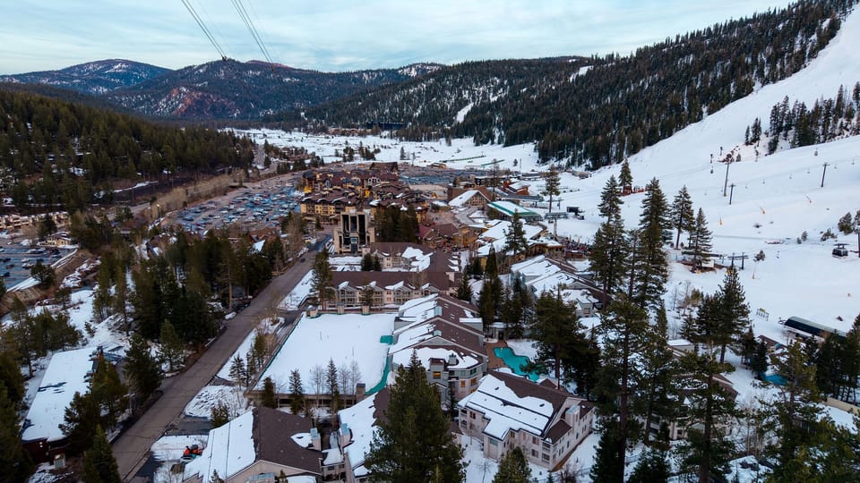 Lake Tahoe magic at sunset—snowy peaks, pine-lined slopes, and the gondola gliding by.