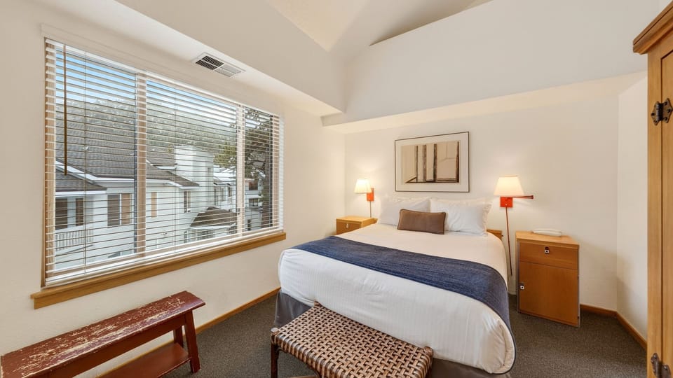 The bedroom features a queen bed and an ensuite bathroom.