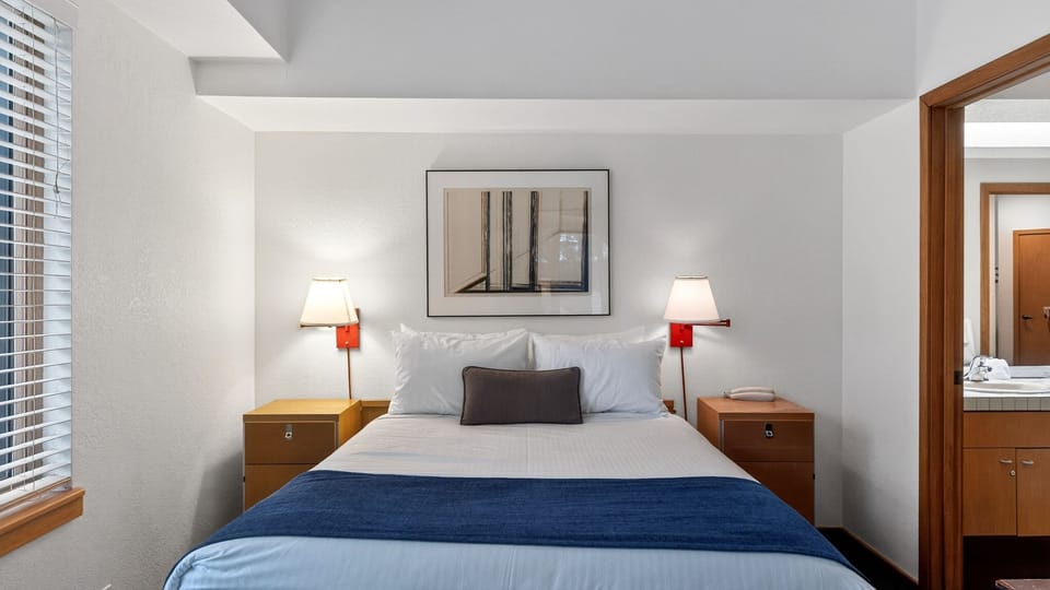 The bedroom features a queen bed and an ensuite bathroom.