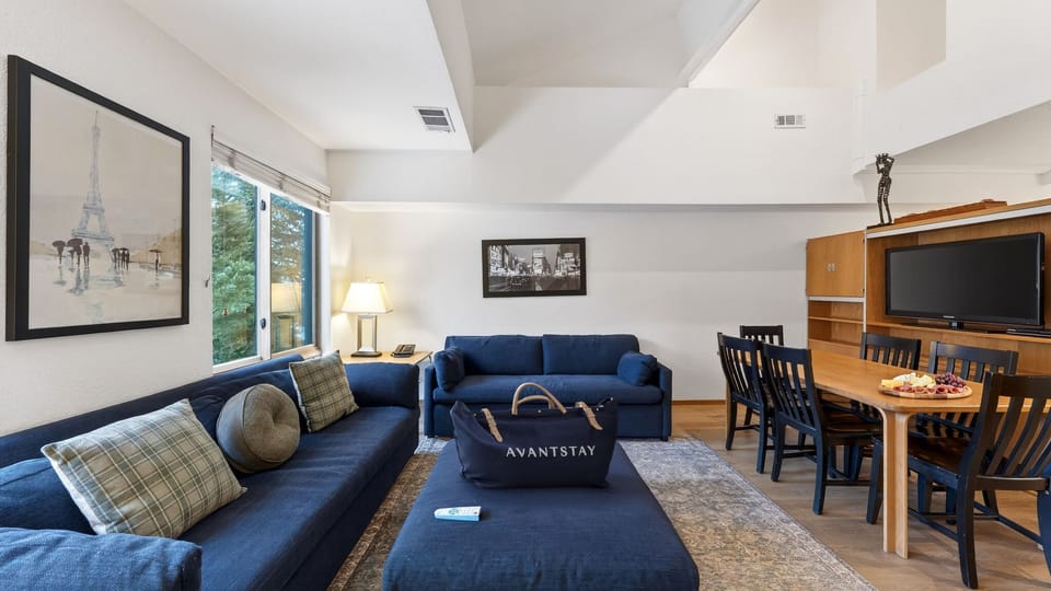 Bright, open living and dining space with vaulted ceilings, 2 sleeper sofas, and plenty of room to gather after a day on the lake.