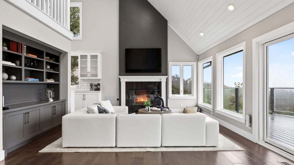 Spacious living room with high ceilings and a modern minimalist fireplace.