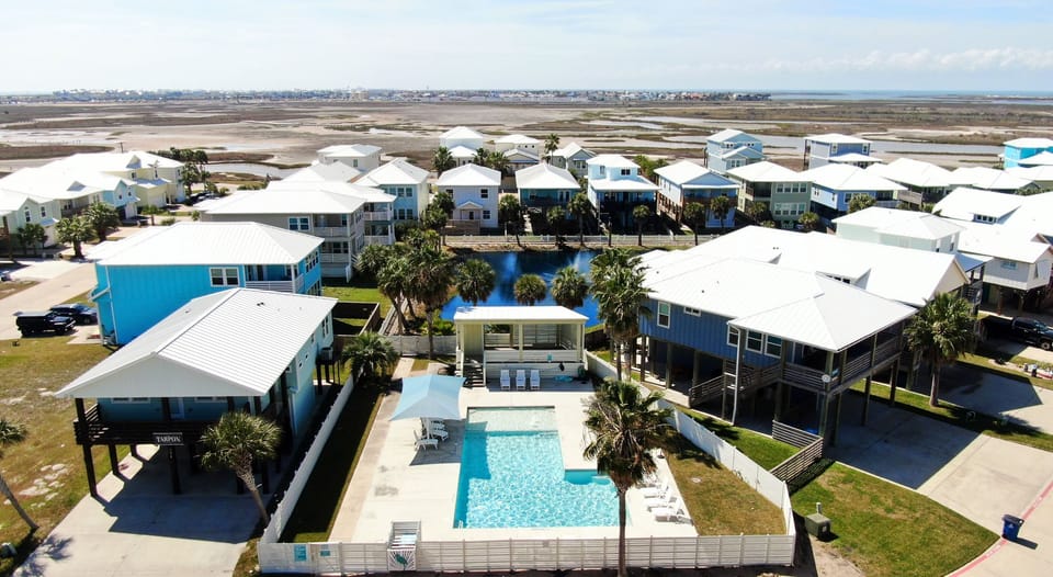 Community pool just steps away, surrounded by coastal cottages and wide-open bay views.