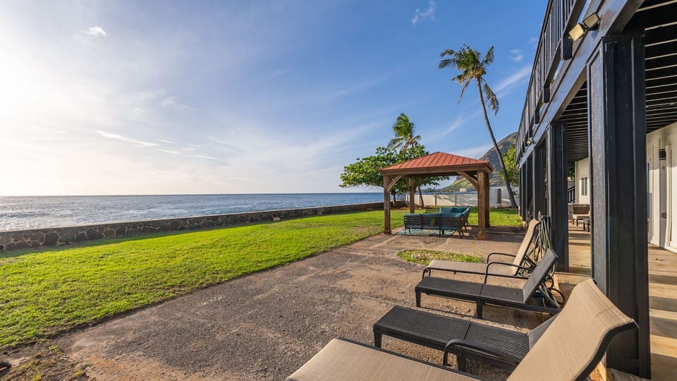 Oceanfront lawn + shaded gazebo lounge—stretch out on the loungers and let the waves set the vibe.