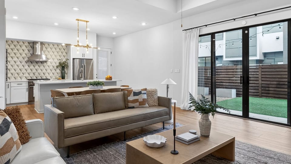 Bright, open-concept living with designer finishes—perfect for relaxing, gathering, and sharing meals in the sleek kitchen and dining space.