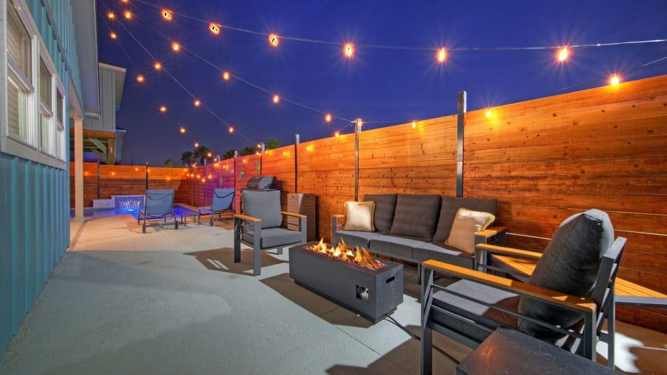 String lights and a fire pit create the perfect setup for relaxed nights after the beach.