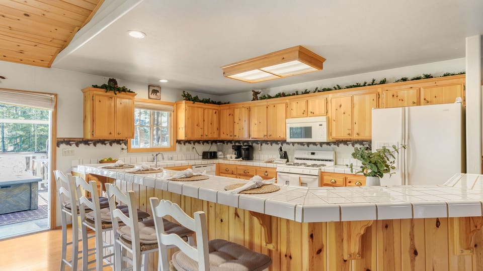 Spacious kitchen with wraparound breakfast bar seating and plenty of room for group meals.