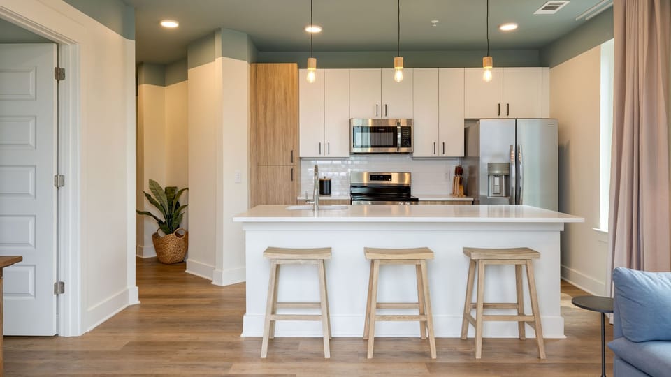 Living room with a sleep sofa and a fully equipped kitchen.