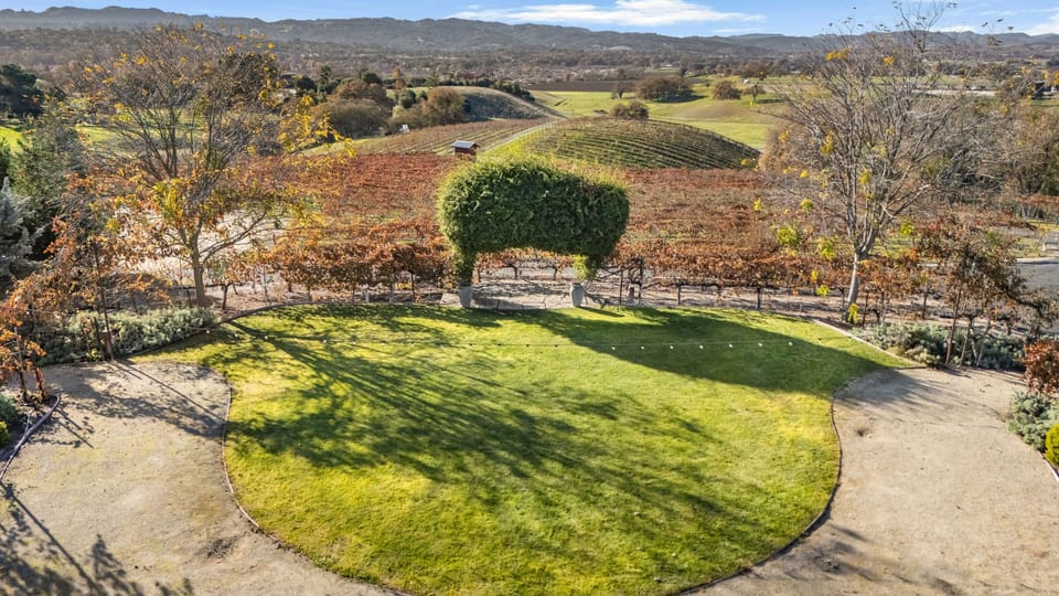 View of the manicured lawn and rolling hills beyond.