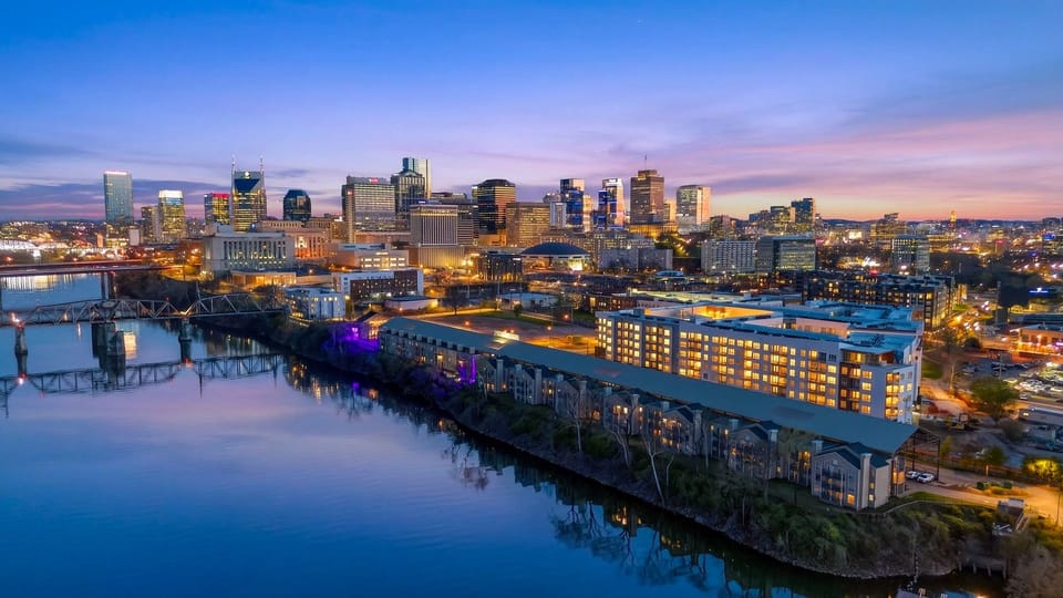 A stunning wide-angle shot of the entire riverfront and city lights.