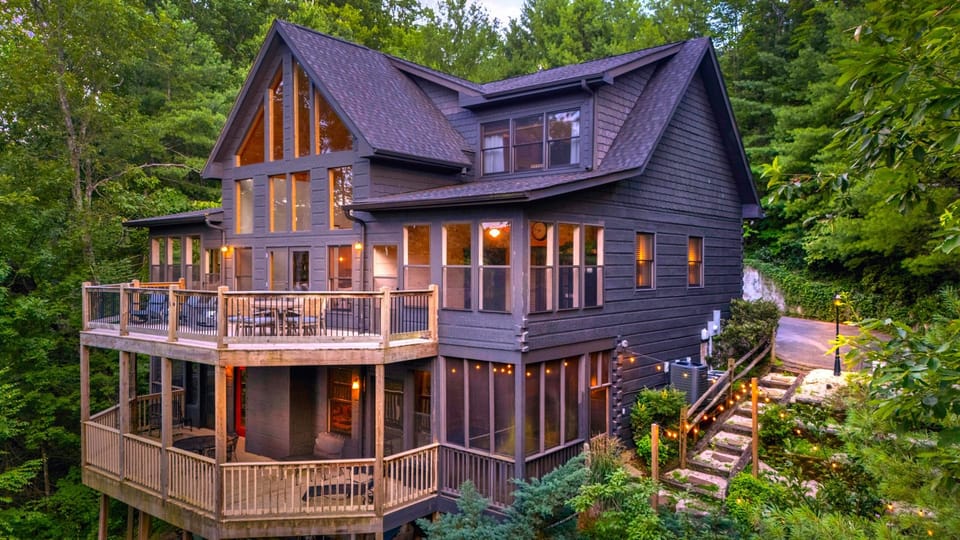 Stunning mountain cabin with multi-level decks and serene wooded setting.
