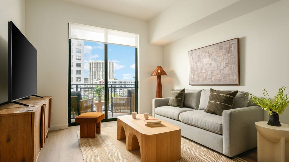 Unit 401: Living room featuring a modern decor and a queen sleeper sofa.