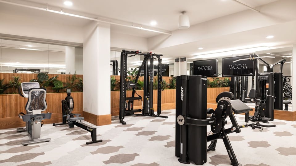 Fitness studio - Maintain your wellness routine in our state-of-the-art gym featuring modern equipment and designer flooring.