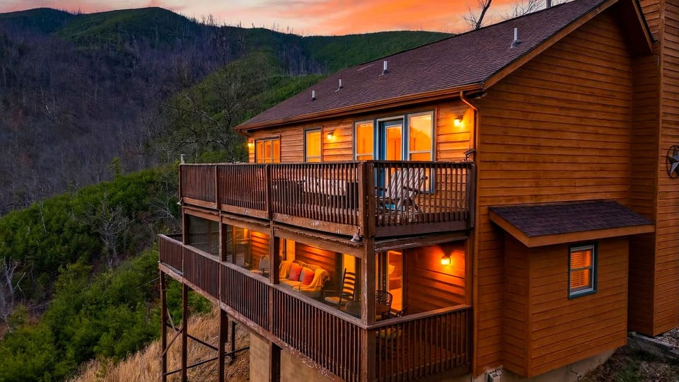 Elevated exterior view of the multi-level log cabin at dusk.