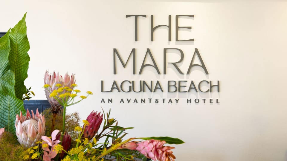 Welcoming hotel lobby with a modern front desk and relaxed seating just steps from Laguna Beach.