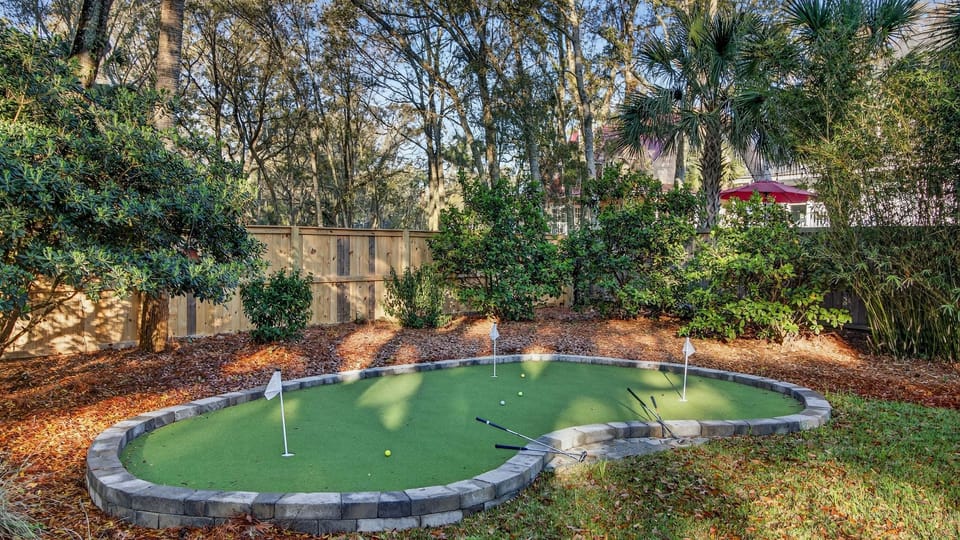 Private putting green surrounded by lush landscaping—perfect for a little friendly competition.
