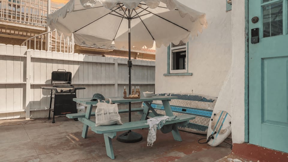 Shared patio with a BBQ grill and al fresco dining table.