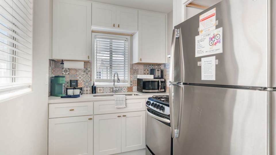 A sleek, full kitchen setup featuring stainless steel appliances and ample cabinetry.