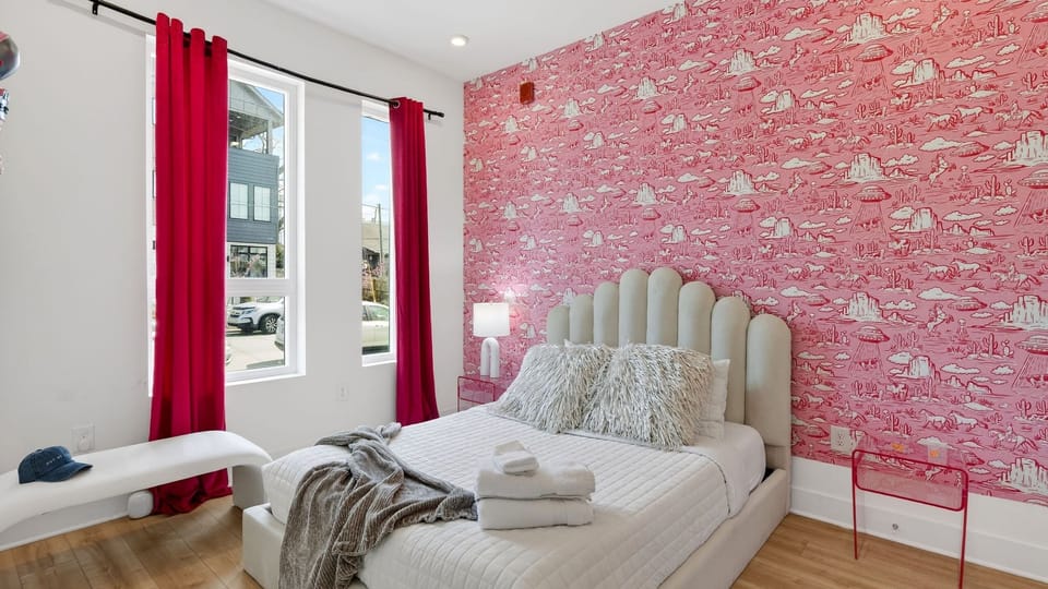 Unit 102: Bedroom 1 features a queen bed and an ensuite bathroom.