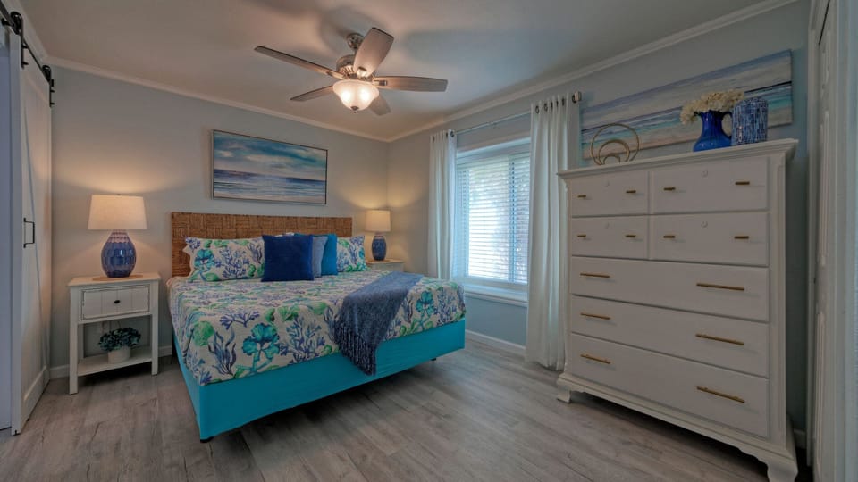 The bedroom features a king bed and a TV.