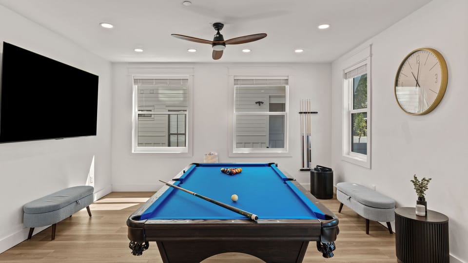 Game room with pool table and TV.