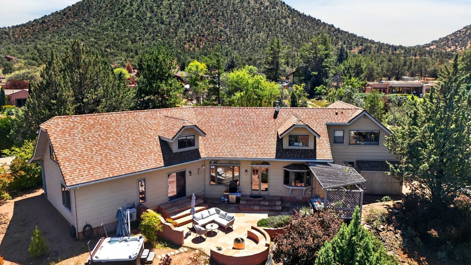 A private Sedona retreat with expansive outdoor living, fire pit, and hot tub—all set against sweeping mountain views.