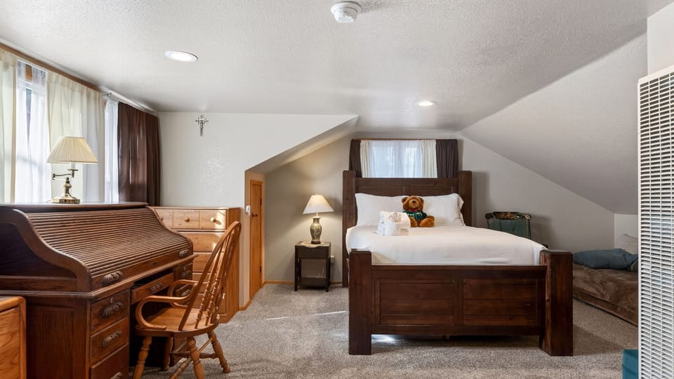 The primary bedroom features a queen bed, TV and an ensuite bathroom.