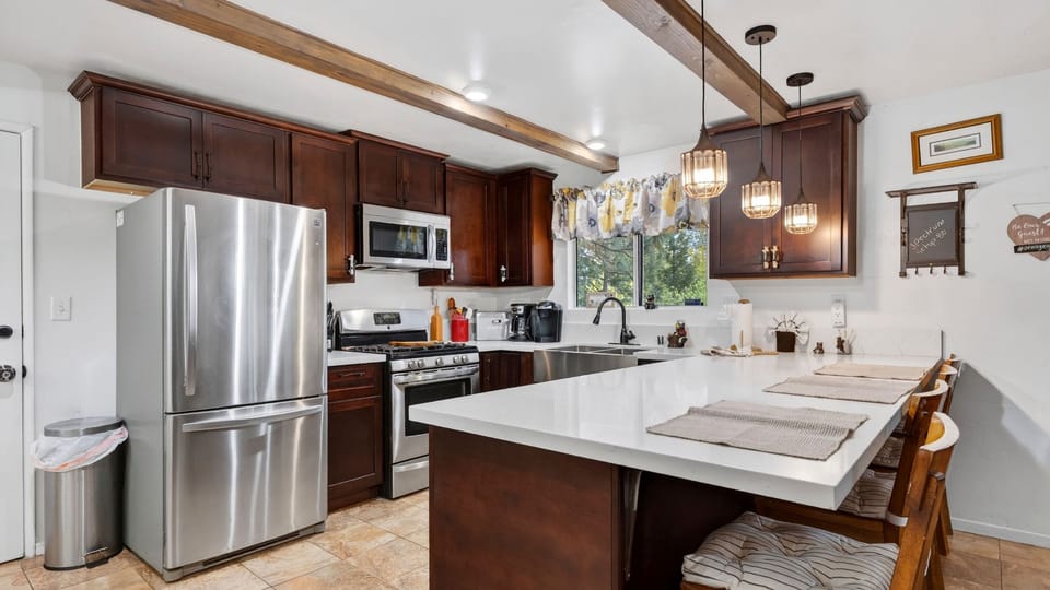 Fully equipped kitchen with spacious island and bar seating.