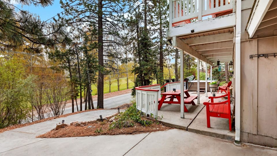 Spacious outdoor patio with dining area and forest views.