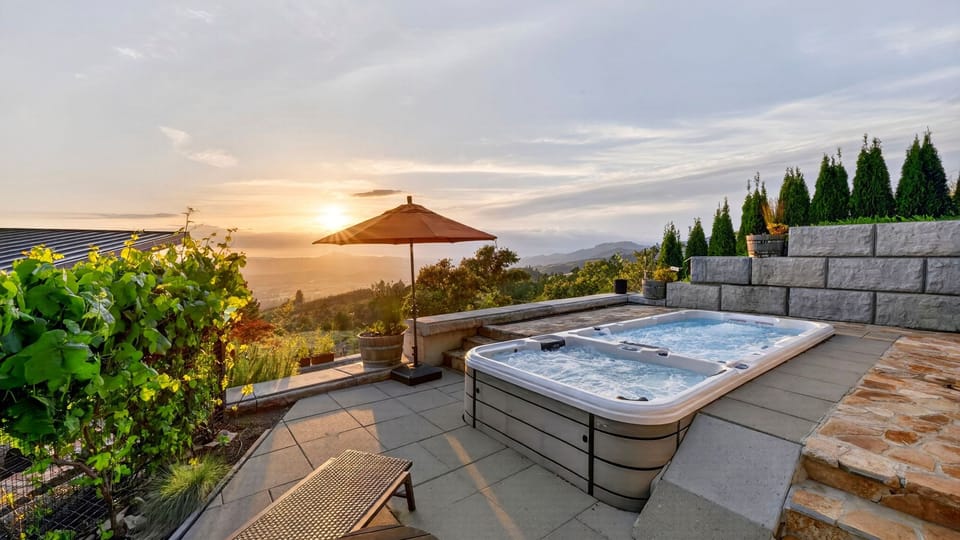 Relaxing spa deck with lounge chairs and shade umbrellas.