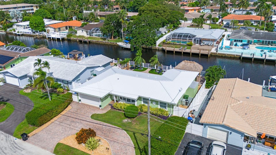 Elevated aerial shot of the home and surrounding saltwater canal.