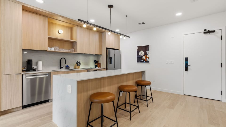 Stunning kitchen with an island and stainless steel appliances. (Unit 210)